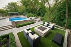modern-sitting-area-garden-rattan-chairs-fireplace-pool-grass-carpet