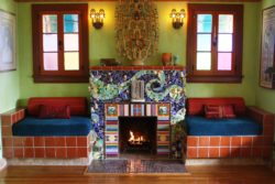 Consider the whimsy that frames the hearth in David Edward Byrd and Jolino Beserras 1928 Spanish bungalow. Clothed in broken ceramics and found and treasured objects, the fireplace resembles an outsize toy. The swirled mosaic pattern and jumble of shiny fun makes one suspect its crowded with spirits. We built the fireplace as our portrait, adds Beserra who in 1997 bought the three-bedroom Silver Lake home with Byrd, his partner of 28 years. The couples birth dates, initials, portraits and other personal items are embedded in the piece. A collection of 1930s and 40s salt and pepper shakers (birds, devils, fat airplanes and a pair of American Indians) are strewn throughout the face and sides. Beserra found many of the items at swap meets. I place narratives in all my work, says Beserra, who based the fireplace partly on Van Gogh's the Starry Night. You cant look at one of my pieces and not think of a time or place in history. Ten different people will relay 10 different stories.