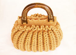 Crocheting hand bag on the white background.