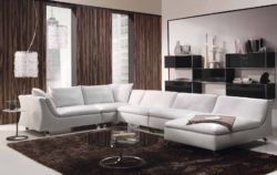 bone-modern-sitting-room-taupe-white-foamy-sofa-set-with-lounge-chair-and-low-legs-brown-flokati-area-rug-round-mirror-occasional-table-with-leg-chrystal-arc-chandelier-black-glossy-floating-