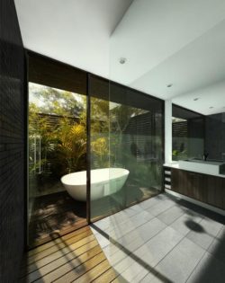 beautiful-garden-view-modern-bathroom-design-with-outdoor-bathtub-idea-and-window-door-mosaic-tile-wall-cabinet-mirror-glass-wall-and-wooden-flooring