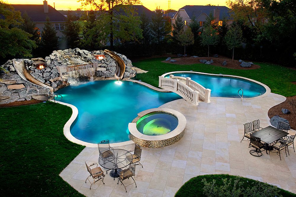 Custom-swimming-pool-and-garden-with-waterfalls-slides-and-a-beautiful-bridge
